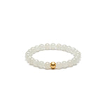 A bracelet featuring white mutton fat jade beads with a gold or silver accent, displayed on a white background.