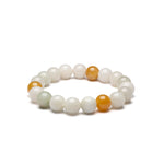 A bracelet with round beads in shades of white and yellow, representing a combination of jade and topaz.