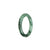 A close-up of a beautiful green jade bangle with intricate patterns, perfect for a child.