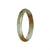 A close-up photo of a beautiful green jade bangle bracelet with a half moon shape. The jade is of high quality and originates from Burma. It has a smooth and polished surface, showcasing its natural beauty. The bracelet has a 54mm diameter, making it a stunning piece of jewelry.