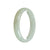 A close-up photo of a stunning white jadeite bracelet with a 56mm half moon design. The bracelet is made of genuine grade A white jadeite, known for its high quality and beautiful appearance. It is a luxurious and elegant piece of jewelry from the brand MAYS™.