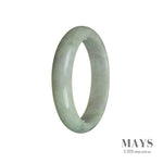 A close-up of a half moon-shaped jade bangle bracelet in vibrant green with hints of lavender, crafted with authentic Grade A jade from Burma.