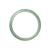 A beautiful half moon-shaped bracelet made of authentic natural light green jadeite jade, measuring 56mm.