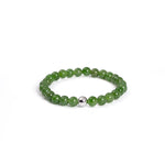 A bracelet featuring green Nephrite jade beads with a metallic accent on a white background.
