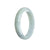 A delicate and beautiful jade bangle in a soft, pale green color with subtle hints of lavender. The bangle is crafted from high-quality jadeite jade and features a unique half moon shape. Perfect for adding an elegant touch to any outfit.