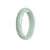 A close-up photo of a pale green jade bracelet with an oval shape. The bracelet is made from genuine, natural jade and measures 56mm in size. It is being sold by MAYS GEMS.