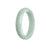 A close-up image of a very pale green jadeite bangle with an oval shape, measuring 56mm in diameter. The bangle is certified as natural and is sold by MAYS.