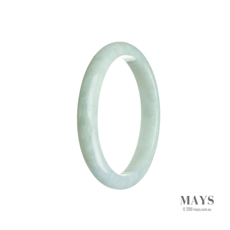Close-up of a beautiful oval-shaped Burmese jade bracelet in a very pale green color with subtle hints of lavender. The bracelet is made of genuine Grade A jade and measures 56mm in size. Exquisite craftsmanship and a stunning piece from MAYS GEMS.