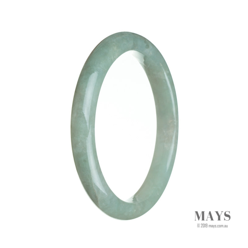 A close-up photo of a pale green jadeite bracelet with a semi-round shape, measuring 64mm in diameter. The bracelet is made of real type A jadeite, known for its high quality and vibrant color. It is a beautiful piece of jewelry from MAYS GEMS.