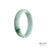 A close-up image of an authentic natural white with green jadeite bangle. The bangle has a flat shape and a diameter of 52mm. It is a product of MAYS™.