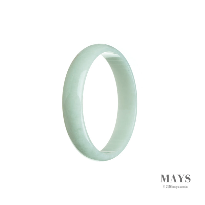 A close-up photo of a real grade A very pale green Burma Jade bangle. The bangle is flat and measures 52mm in diameter. The smooth surface of the bangle showcases the beautiful pale green color of the jade.