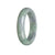 A close-up image of a green and lavender jadeite bangle bracelet, with a half-moon shape and a diameter of 57mm. The bracelet is certified Grade A and is sold by MAYS GEMS.