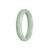 A close-up photo of a light green jadeite bracelet in the shape of a half moon. The bracelet is made with high-quality grade A jadeite and measures 56mm in diameter. It has a smooth and polished surface, showcasing the natural beauty of the jadeite stone. The bracelet is from MAYS GEMS, a reputable jewelry brand.