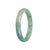 A half-moon-shaped bangle bracelet made of untreated green Burma Jade, certified for its authenticity.