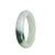A pale green traditional jade bangle with a half moon shape, measuring 52mm. This authentic Grade A piece is from MAYS GEMS.