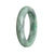 A beautiful green jadeite bangle bracelet with a half moon design measuring 59mm in size.