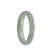 A close-up image of a traditional jade bangle bracelet in a greyish green color. The bracelet is made of genuine untreated jade and has a half-moon shape. It measures 55mm in diameter.