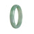 A close-up photo of a bracelet made with authentic untreated icy apple green Burmese Jade. The bracelet has a half moon shape and measures 56mm in size. It is a high-quality piece from the brand MAYS™.