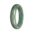 A green jade bracelet with a half moon shape, made from genuine Type A traditional jade, sold by MAYS.