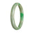 A close-up photo of a green Burmese jade bangle bracelet with a semi-round shape, measuring 64mm in diameter. The bracelet is made of genuine Type A jade and has a vibrant green color. It is a beautiful piece of jewelry crafted by MAYS GEMS.