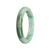 Close-up of a green jade bangle with a semi-round shape, measuring 57mm in diameter. The bangle is made of certified Type A green jadeite jade, known for its exquisite quality. The brand name "MAYS™" is engraved discreetly on the inner side.