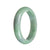 A close-up image of an authentic Grade A Green Burma Jade Bangle, featuring a half-moon shape with a diameter of 59mm. This stunning piece of jewelry is crafted with the highest quality jade, showcasing its vibrant green color and exquisite craftsmanship. A symbol of elegance and luxury, this bangle is a perfect addition to any jewelry collection.
