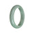 A pale green Burmese Jade Bangle with a half moon shape, certified as Grade A by MAYS GEMS.