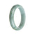 A pale green traditional jade bracelet in a half moon shape, with a real Type A jade stone.