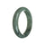 A close-up image of a real untreated green jadeite bangle bracelet. The bracelet is semi-round in shape and measures 59mm in diameter. The vibrant green color of the jadeite is showcased, highlighting its natural beauty. The bracelet is from MAYS GEMS.