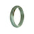 A high-quality, authentic green Burma Jade bangle bracelet in the shape of a 56mm half moon. Perfect for adding a touch of elegance and natural beauty to any outfit.