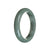 A close-up image of a real grade A grey traditional jade bracelet. The bracelet is 59mm in size and has a semi-round shape. It is a product of MAYS GEMS.