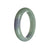 A close-up image of a green and lavender jade bangle bracelet, with a semi-round shape and a diameter of 57mm. The bracelet's surface appears untreated, showcasing the natural beauty of the jade stone. Created by MAYS GEMS.