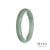 A half moon-shaped bangle made of genuine untreated green with white jadeite, measuring 63mm in size.
