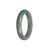 A half-moon shaped jade bangle in untreated green with grey tones, showcasing a traditional design.