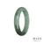 A close-up image of an authentic Type A Green Flower Burmese Jade Bangle Bracelet. The bracelet has a half-moon shape and measures 58mm in diameter. It is a stunning piece of jewelry from MAYS GEMS.