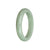 A green jade bangle in the shape of a half moon, made from authentic Grade A traditional jade.