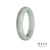 A lavendar and pale green jade bangle with a half moon design, made from high quality materials.