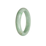 A close-up photo of a half-moon-shaped bangle bracelet made of genuine untreated green jadeite. The bracelet has a smooth and polished surface, showcasing the natural beauty of the jadeite. The vibrant green color of the stone is highlighted against the light, capturing attention and adding a touch of elegance to any outfit. The bracelet measures 53mm in diameter, making it a perfect fit for those with smaller wrists. A high-quality piece of jewelry that exudes both sophistication and uniqueness.