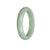 A beautiful green jade bracelet in a half moon shape, showcasing its natural beauty and elegance.