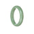 A light green Burmese jade bangle bracelet with a half moon design, measuring 55mm in diameter.