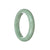 A close-up image of a light green Burma Jade bracelet, featuring a half-moon shape with a diameter of 58mm.