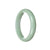 A light green Jadeite Jade bangle bracelet in the shape of a 60mm half moon, crafted with exceptional quality and authenticity. Perfect for adding a touch of elegance and natural beauty to any outfit.