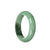 Image of an authentic Grade A Burmese Jade Bangle, with a vibrant green color and a dark green patch. The bangle is in a half-moon shape, measuring 55mm in diameter. It is a high-quality piece of jade jewelry from MAYS.