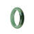 A half-moon shaped traditional jade bangle bracelet in real untreated green with a dark green patch.