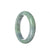 A lavender-colored jade bangle with a half-moon shape, showcasing the beauty of natural materials.