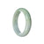 A beautiful pale green and lavender jadeite bangle bracelet, featuring a half moon shape.
