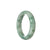 A pale green jadeite jade bangle bracelet with a half moon design, certified Grade A.