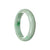 A beautiful pale green jade bangle with a half moon shape, made from genuine Grade A Burmese jade. The bangle has a stunning emerald green color and measures 59mm in size. Designed by MAYS™.