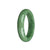 A close-up image of a Real Grade A Green Jade Bangle in a 58mm size, shaped like a half moon. It is a beautiful piece of jewelry from the MAYS™ collection.