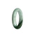A half-moon shaped jadeite bangle bracelet in a beautiful pale green with hints of olive green.
